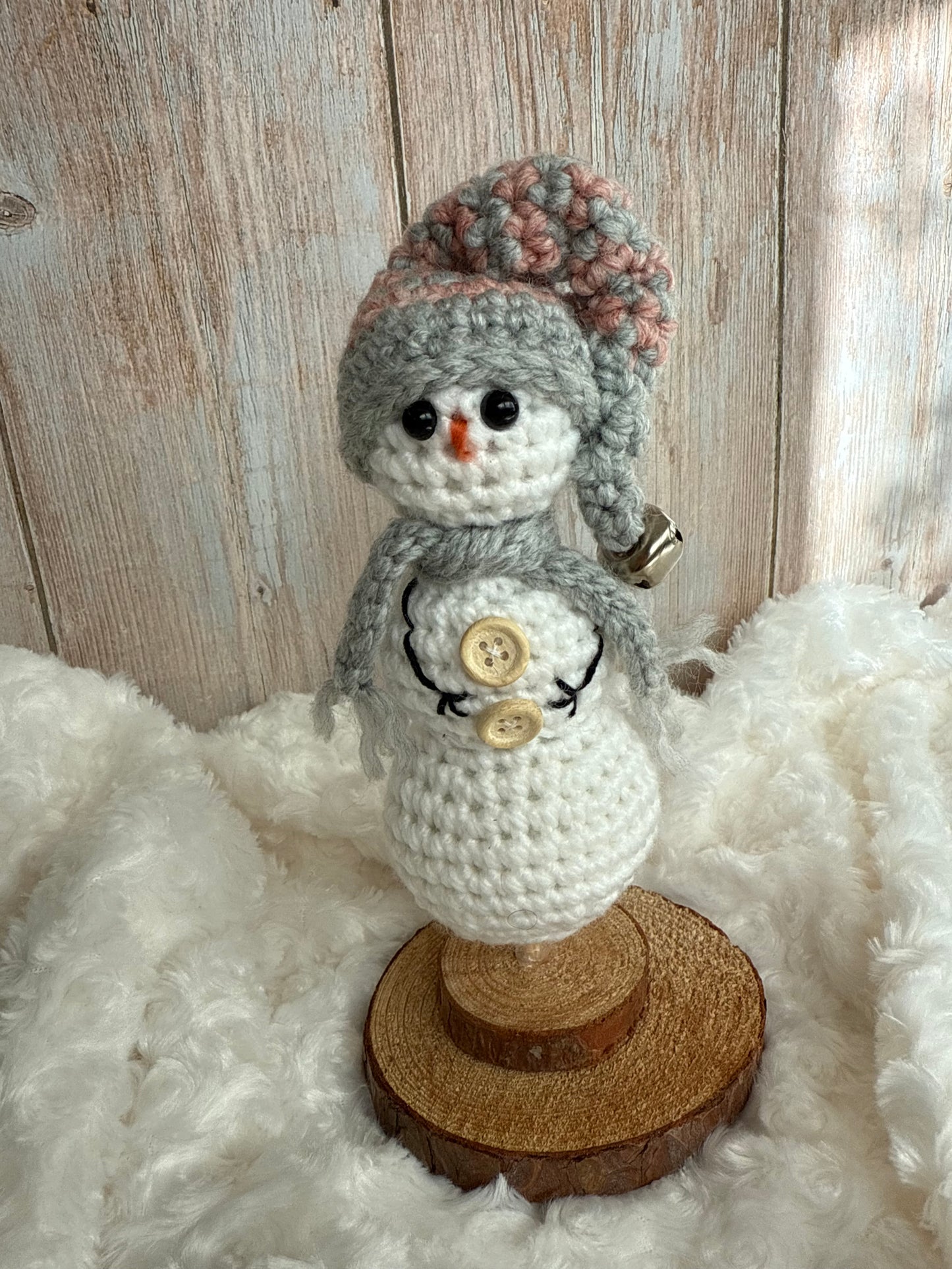 Handmade Crochet Snowman with Hat and Scarf – Winter Table Decor, Crochet Snowman on Wooden Base – Cozy Rustic Christmas Decoration, Mini Crochet Snowman – Cute Handmade Holiday Figurine, Crochet Snowman with Button Details – Perfect Winter Gift
