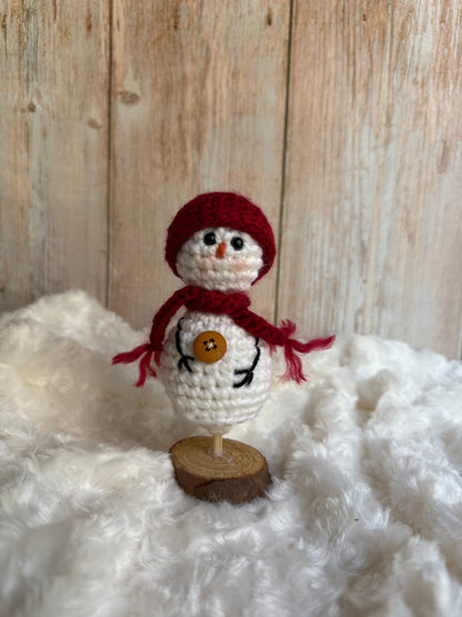 Handmade Crochet Snowman with Hat and Scarf – Winter Table Decor, Crochet Snowman on Wooden Base – Cozy Rustic Christmas Decoration, Mini Crochet Snowman – Cute Handmade Holiday Figurine, Crochet Snowman with Button Details – Perfect Winter Gift